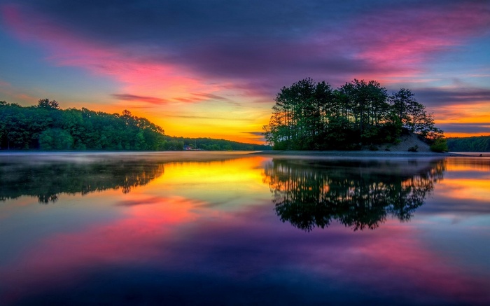Colorful Massachusetts lake island at sunrise with mist