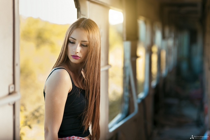 Woman with long brown hair in a train car
