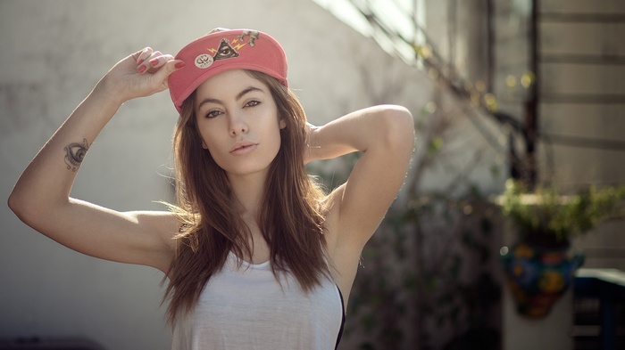 Woman wearing a pink baseball cap outdoors