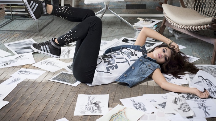 Selena Gomez lying on the floor with drawings
