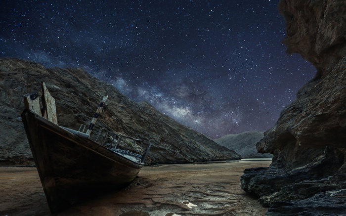 Abandoned boat under the Milky Way