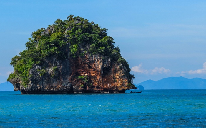 Tropical island with a boat in the sea