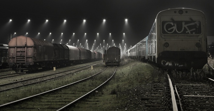 Trains in a foggy rail yard at night in Denmark