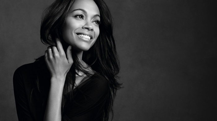 Zoe Saldana smiling in monochrome portrait