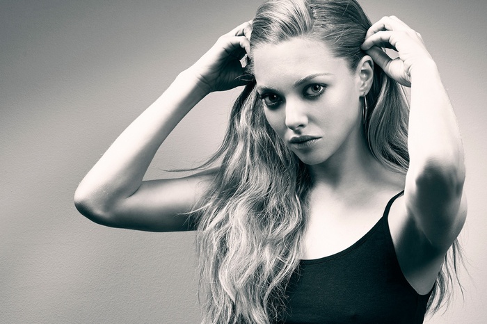 Amanda Seyfried with hands on head, monochrome portrait