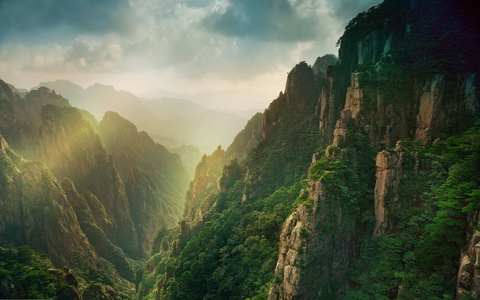Misty mountain canyon with sun rays in China