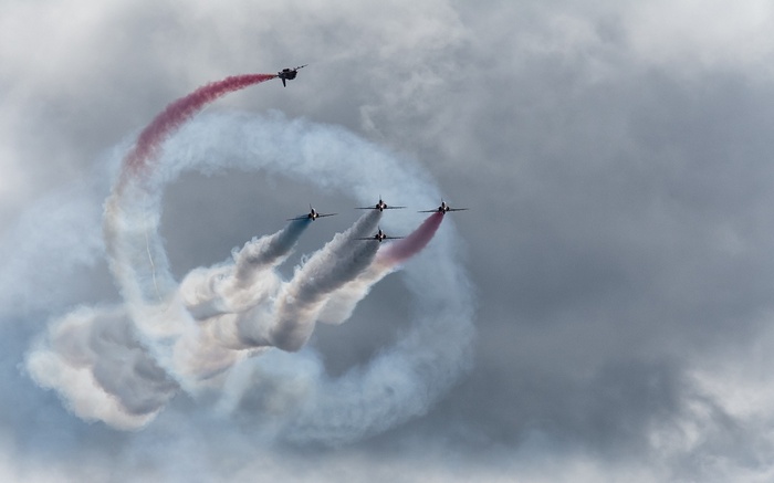 Air Force jets perform aerobatics with smoke trails
