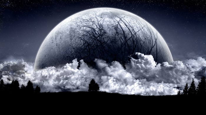 Giant moon rising over clouds and trees