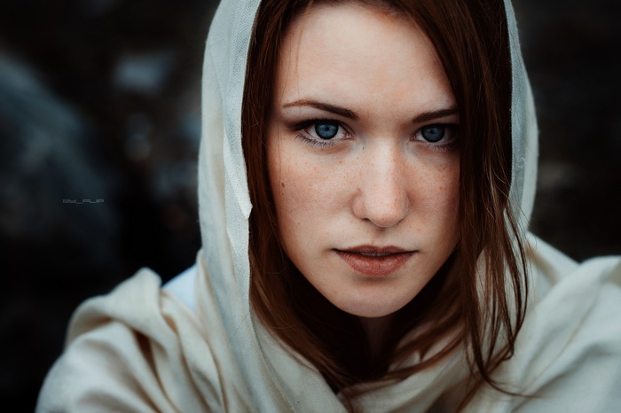 Woman with blue eyes wearing a hood