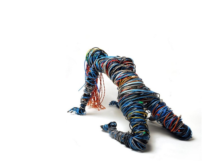Sculpture of a human figure made of colorful wires