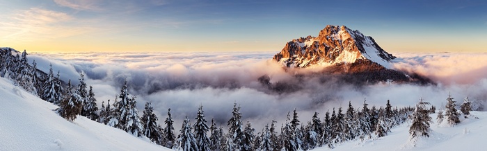Winter mountain landscape with clouds and pine trees in Slovakia