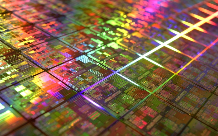 Close-up of a silicon wafer with colorful light reflections