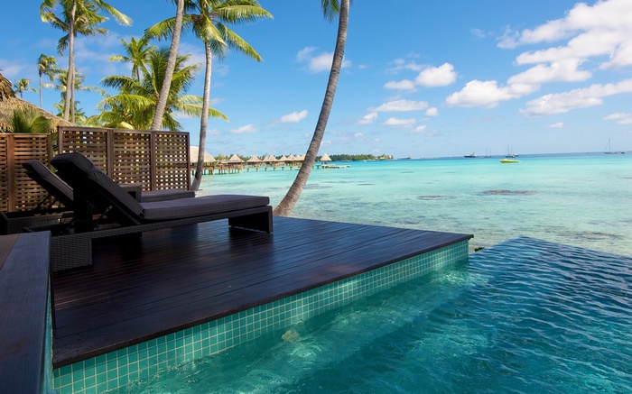 Tropical resort with overwater bungalows and infinity pool