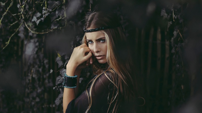 Woman with blonde hair and blue eyes wearing a headband