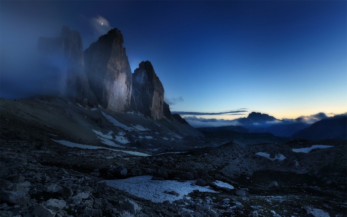 Tre Cime di Lavaredo mountains at dusk with moon