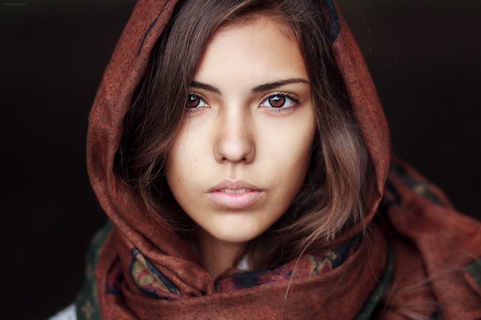 Woman with brown scarf and hazel eyes