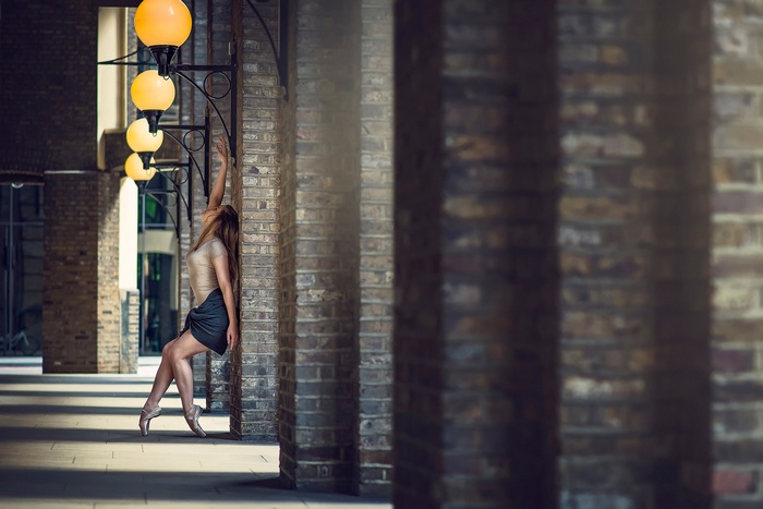 Marine Fauvet, ballerina, dancing by brick columns
