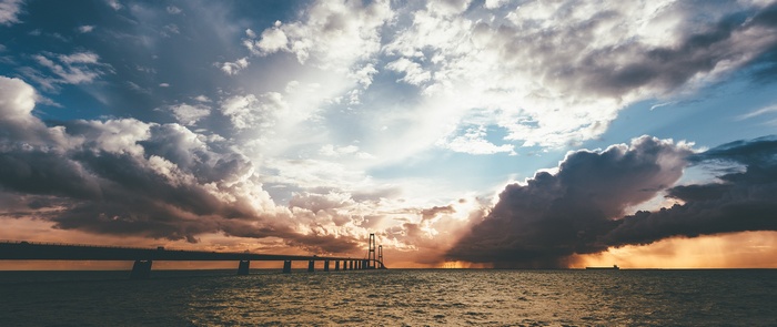 Bridge over the sea with dramatic clouds