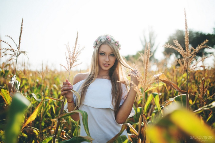 Woman with flower crown in cornfield