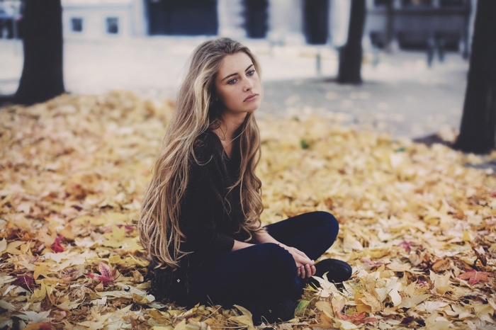 Camille Rochette sitting on fallen leaves