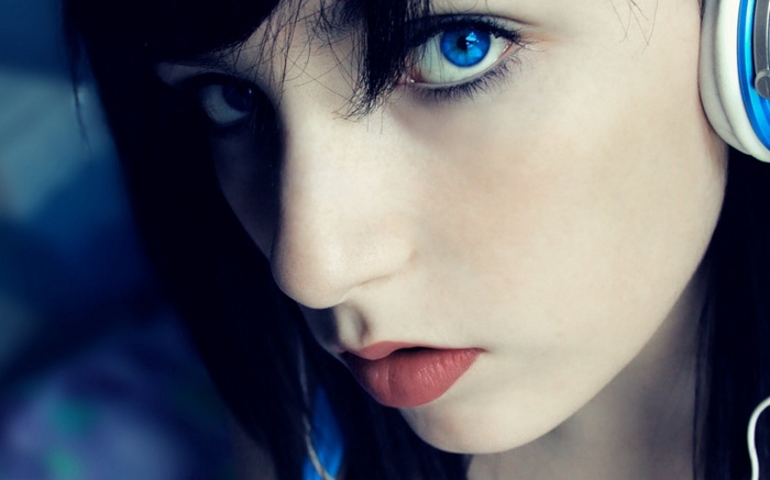 Woman with blue eyes wearing headphones