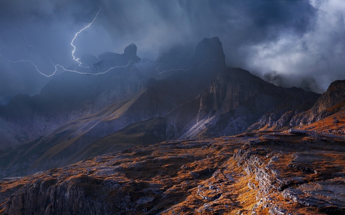 Lightning strikes over the Dolomites mountains in Italy