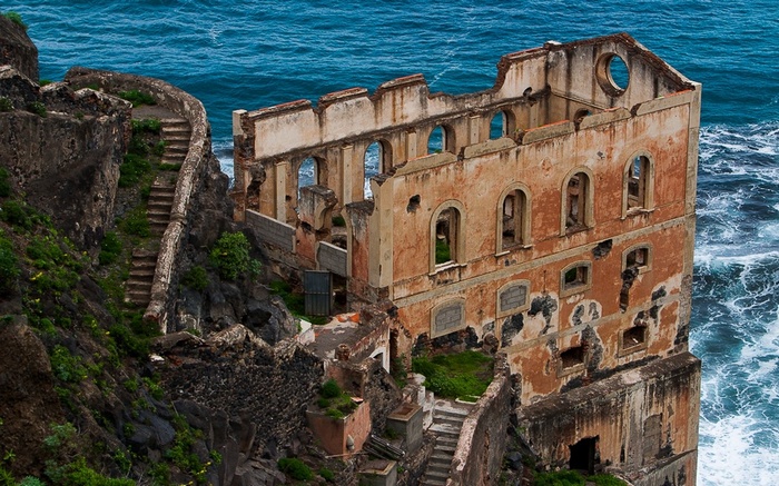 Abandoned building on a rocky coast by the sea