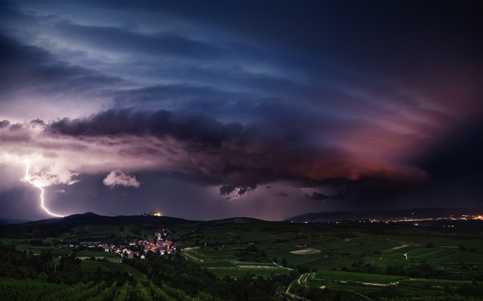 Lightning strikes over a village in Austria during a storm