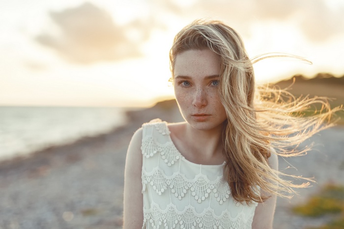 Portrait of a woman with freckles outdoors