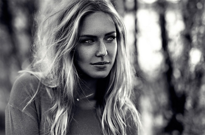 Monochrome portrait of a woman with freckles