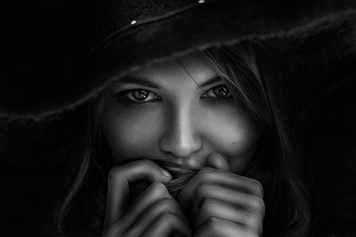 Monochrome portrait of a woman wearing a hat