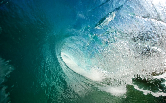 Inside a turquoise ocean wave barrel