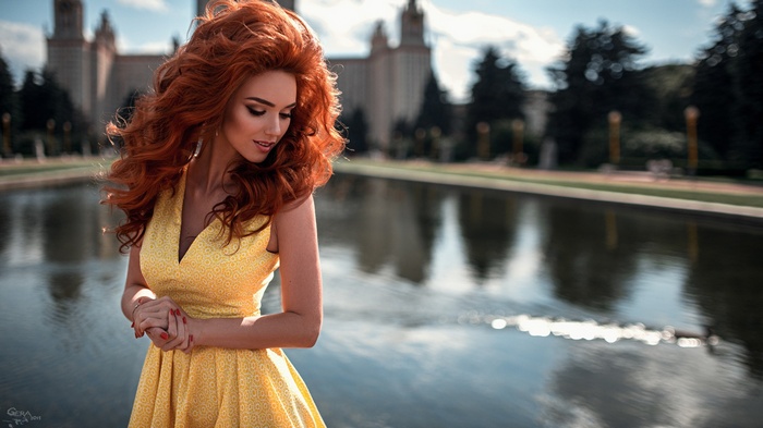 Woman with red curly hair in a yellow dress by Georgy Chernyadyev