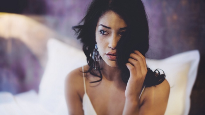 Woman with dark hair and blue eyes wearing white underwear