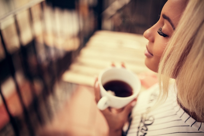 Woman holding a cup of tea with blonde hair
