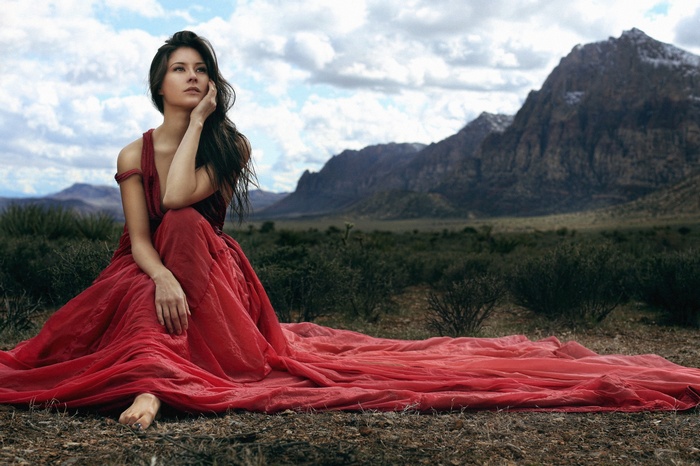 Woman in Red Dress in Mountain Landscape