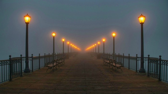 Pier with street lights in the fog