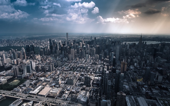 Aerial view of New York City skyscrapers under dramatic clouds