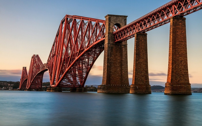 The Forth Bridge over water at sunset