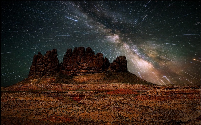 Milky Way over desert rock formations under a starry night sky