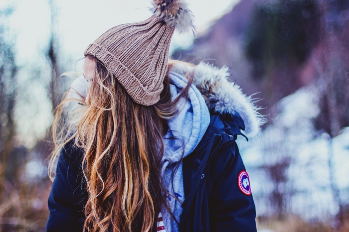 Woman in winter coat and beanie in snow