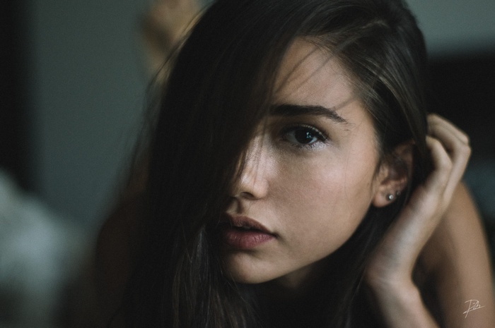 Portrait of a young woman with hair covering her face