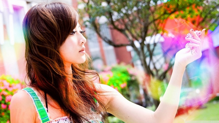 Woman holding flowers with colorful light effects