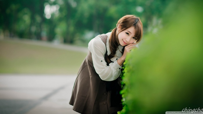 Asian woman with brown hair in a park