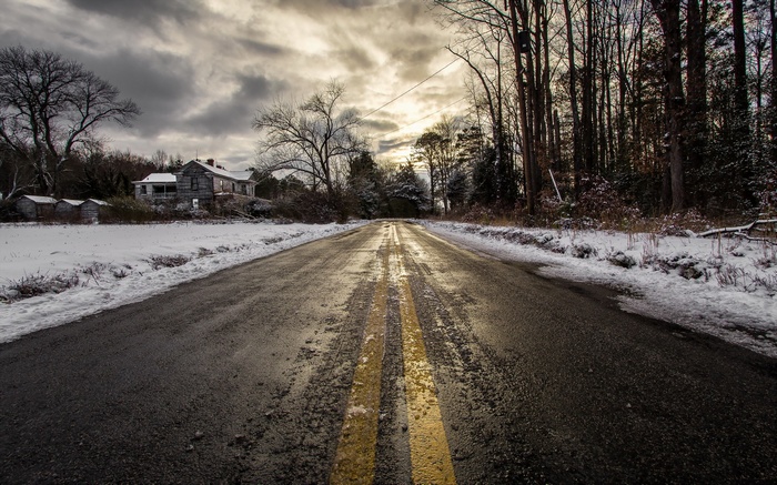 Abandoned house on a snowy road in winter