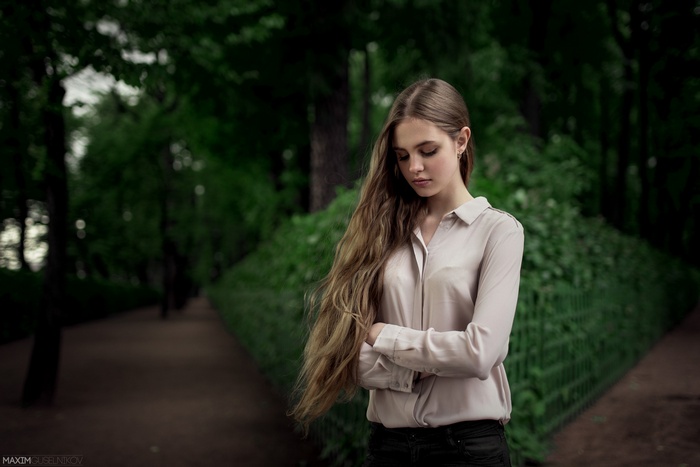Woman with long auburn hair in a park