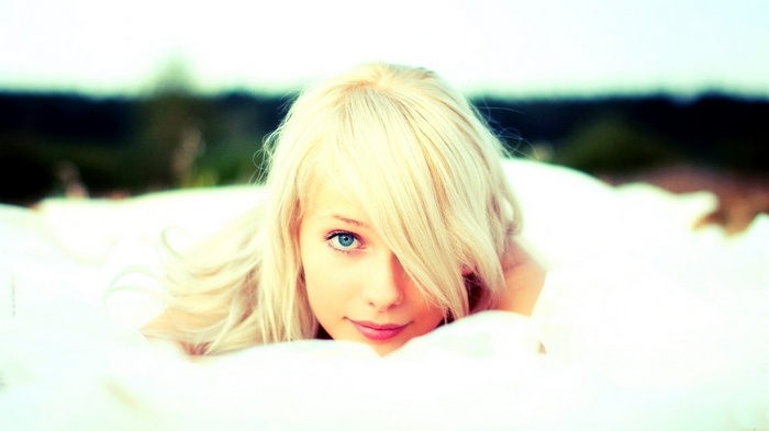 Woman with blonde hair and blue eyes outdoors