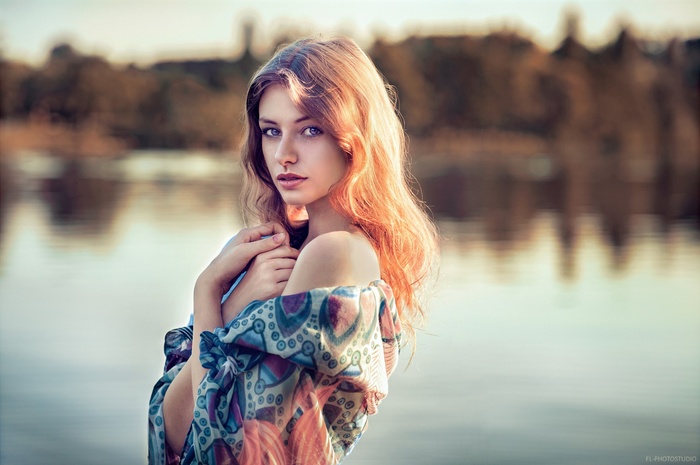 Woman with auburn hair looking at viewer