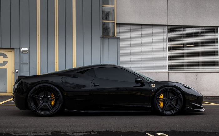Black Ferrari 458 parked in front of a building