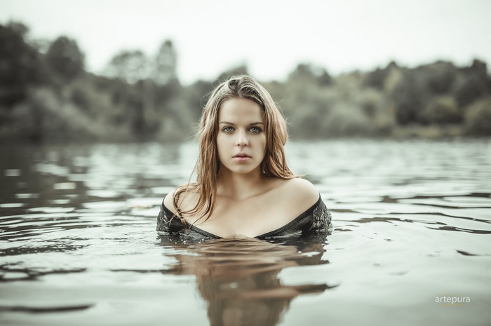 Woman in a black dress in a river